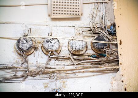 Old telephone junction boxes on a white wall Stock Photo