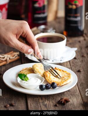Russian cottage cheese pancakes with sour cream Stock Photo