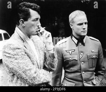 DEAN MARTIN and MARLON BRANDO on set candid during filming of THE YOUNG LIONS 1958 director EDWARD DMYTRYK novel Irwin Shaw screenplay Edward Anhalt Twentieth Century Fox Stock Photo