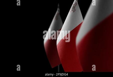 Small national flags of the Malta on a black background Stock Photo