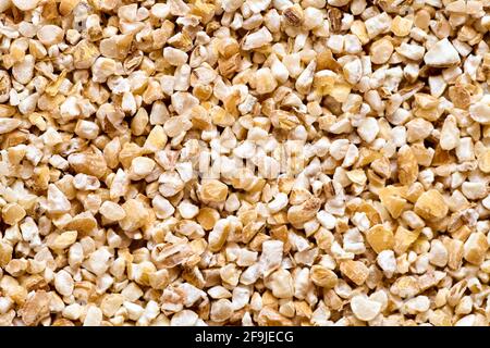 Raw dried broken barley cereal grain texture background macro closeup. Barley groats, coarse barley semolina. Concept of healthy eating protein diet a Stock Photo