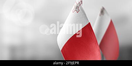 Small national flags of the Malta on a light blurry background Stock Photo