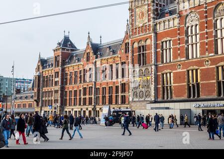 Amsterdam, Netherlands - March 11, 2017: View of People Walking in front of the Amsterdam Centraal Stock Photo