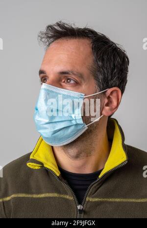 Portrait of a man wearing a face mask to protect against infectious diseases Stock Photo
