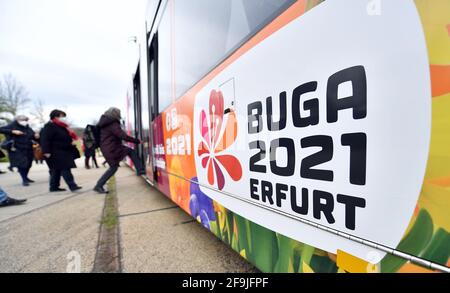 Erfurt, Germany. 16th Apr, 2021. Participants of the press tour board a tram with the Buga logo in front of the grounds of the Federal Horticultural Show (BUGA) in egapark. From 23 April to 10 October 2021, the summer festival with horticultural showcase is to take place on two exhibition sites in Erfurt. In addition, 25 BUGA outdoor locations are planned throughout Thuringia. Credit: Martin Schutt/dpa-Zentralbild/ZB/dpa/Alamy Live News Stock Photo