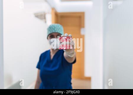 Doctor holding a denture with brackets Stock Photo