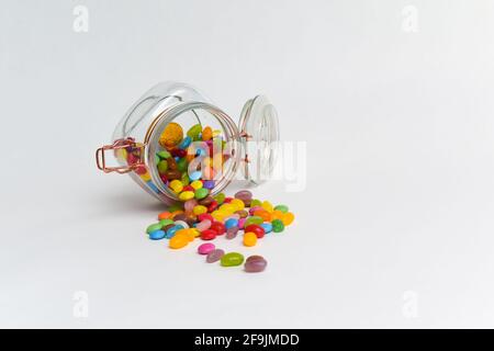 Junk food sweets and chocolate candy in a jar isolated Stock Photo