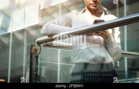 Portrait of a businesswoman are standing on the background of glass offices. Stock Photo
