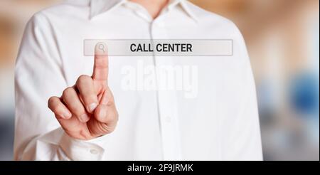 Male hand touches an internet search bar on a virtual screen and searches the web for call center. Online customer service concept. Stock Photo