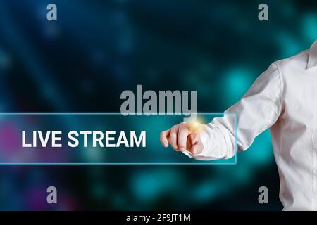 Male hand pressing the word live stream on a virtual search display bar. Media Internet Online Networking Concept. Stock Photo
