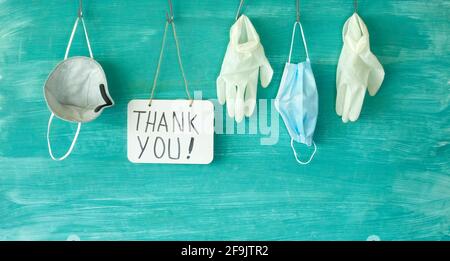 We thank the medical staff  for their devoted work during cornavirus epidemic, symbolic picture,medical gloves, face masks and the message Thank you Stock Photo