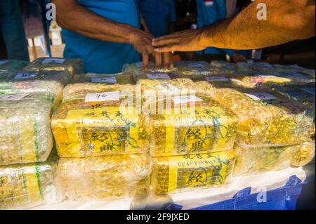 Military personnel seen guarding the evidence of methamphetamine and ecstasy as evidence of a case of drug trafficking at the Belawan Lantamal I Command Headquarters in North Sumatra, Indonesia on April 19, 2021. The Indonesian national navy has successfully arrested two smugglers of more than 100 kilogerams of amphetamine (crystal methamphetamine and ecstasy) drugs that are suspected of being carried from Malaysia - China in the waters of the Asahan River, North Sumatra, Indonesia on April 18, 2021. The disclosure was an intelligence collaboration and routine patrols, said the Commander of Ko Stock Photo