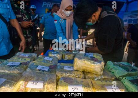 Military personnel seen guarding the evidence of methamphetamine and ecstasy as evidence of a case of drug trafficking at the Belawan Lantamal I Command Headquarters in North Sumatra, Indonesia on April 19, 2021. The Indonesian national navy has successfully arrested two smugglers of more than 100 kilogerams of amphetamine (crystal methamphetamine and ecstasy) drugs that are suspected of being carried from Malaysia - China in the waters of the Asahan River, North Sumatra, Indonesia on April 18, 2021. The disclosure was an intelligence collaboration and routine patrols, said the Commander of Ko Stock Photo