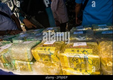 Military personnel seen guarding the evidence of methamphetamine and ecstasy as evidence of a case of drug trafficking at the Belawan Lantamal I Command Headquarters in North Sumatra, Indonesia on April 19, 2021. The Indonesian national navy has successfully arrested two smugglers of more than 100 kilogerams of amphetamine (crystal methamphetamine and ecstasy) drugs that are suspected of being carried from Malaysia - China in the waters of the Asahan River, North Sumatra, Indonesia on April 18, 2021. The disclosure was an intelligence collaboration and routine patrols, said the Commander of Ko Stock Photo