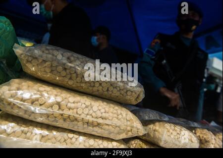 Military personnel seen guarding the evidence of methamphetamine and ecstasy as evidence of a case of drug trafficking at the Belawan Lantamal I Command Headquarters in North Sumatra, Indonesia on April 19, 2021. The Indonesian national navy has successfully arrested two smugglers of more than 100 kilogerams of amphetamine (crystal methamphetamine and ecstasy) drugs that are suspected of being carried from Malaysia - China in the waters of the Asahan River, North Sumatra, Indonesia on April 18, 2021. The disclosure was an intelligence collaboration and routine patrols, said the Commander of Ko Stock Photo