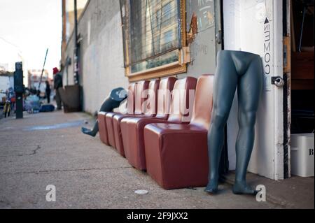 Take a seat. Half mannequin body waiting by the door. Funny scene of a Sunday flea market around Brick Lane, East London, UK. Jan 2013 Stock Photo