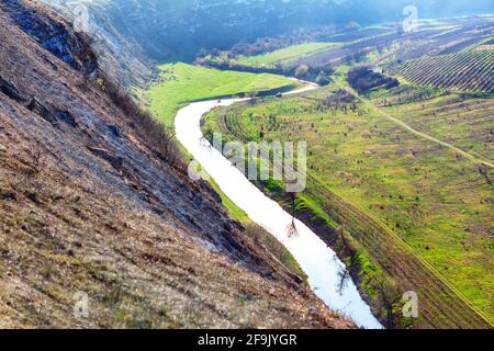 Green mountain valley with river . Panoramic view of riverside fields