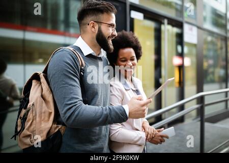 Happy business people, students having fun, smiling, talking in the city Stock Photo