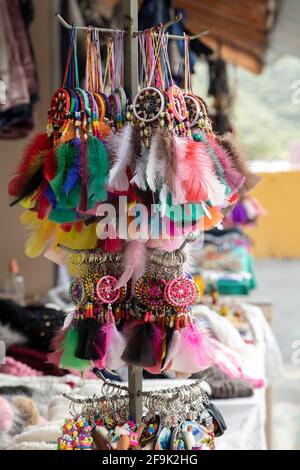 detail of several keychains with colorful dream catchers on display in a craft store Stock Photo