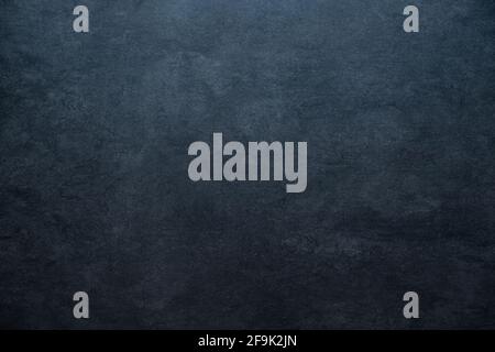 old blackboard concrete stone background texture with light gradient and copy space blue colored Stock Photo