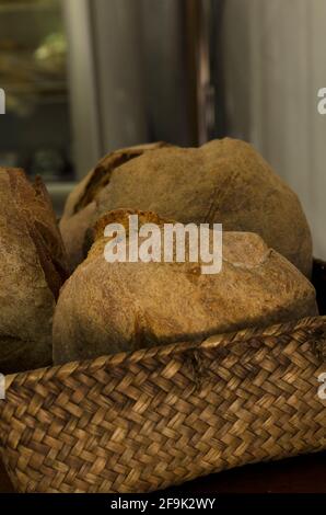 whole wheat homemade bread on wicker tray, bread baked in bakery Stock Photo