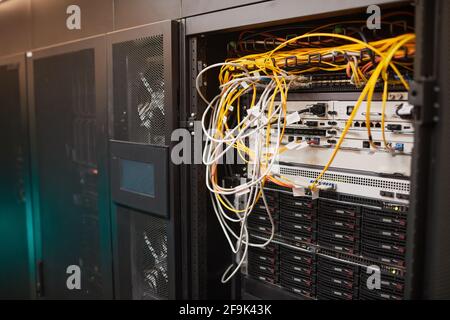 Background image of server cabinet with cables and wires at data center, supercomputer network, copy space Stock Photo