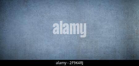 scratched and stained concrete wall background with blue tint Stock Photo