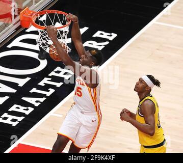 Atlanta, USA. 18th Apr, 2021. Atlanta Hawks center Clint Capela goes in for back-to-back slams against Indiana Pacers center Myles Turner, taking the pass from Trae Young on Sunday, April 18, 2021, at State Farm Arena in Atlanta, Georgia. (Photo by Curtis Compton/Atlanta Journal-Constitution/TNS/Sipa USA) Credit: Sipa USA/Alamy Live News Stock Photo