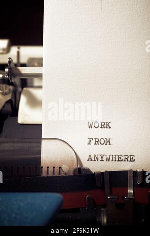 Work from anywhere phrase written with a typewriter. Stock Photo