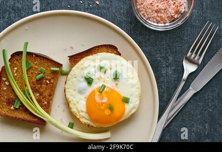 Fried rye bread with scrambled eggs, breakfast concept, top view Stock Photo