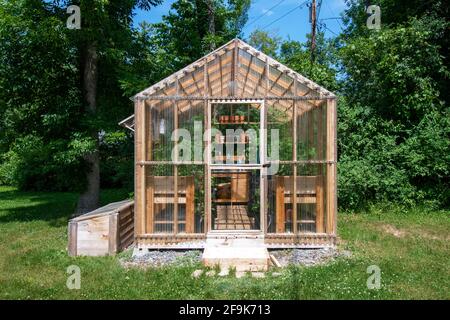 Wooden domestic greenhouse for growing vegetables Stock Photo