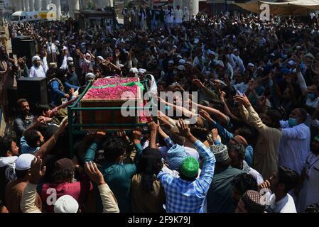 Lahore, Pakistan. 19th Apr, 2021. Supporters of Tehreek-e-Labbaik Pakistan (TLP) party carry the coffin and shout slogans during the funeral prayer of their colleague of a comrade who was killed in the Sunday's clash with security forces, a protest after their leader was detained following his calls for the expulsion of the French ambassador in Lahore. (Photo by Rana Sajid Hussain/Pacific Press) Credit: Pacific Press Media Production Corp./Alamy Live News Stock Photo