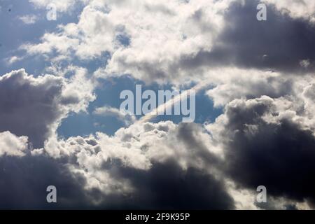 sky with storm clouds and chemtrail airplane contrail Stock Photo