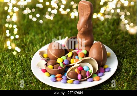 chocolate bunny, eggs and candy drops on plate Stock Photo