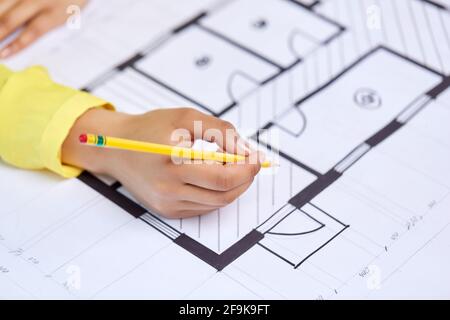 close up of architect's hand with blueprint Stock Photo
