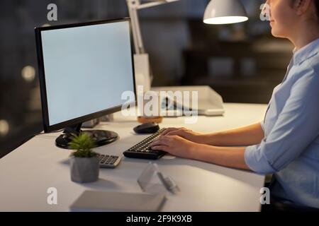 businesswoman working on computer at night office Stock Photo