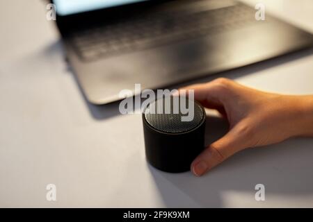 hand using smart speaker at night office Stock Photo