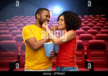 happy african american couple eating popcorn Stock Photo