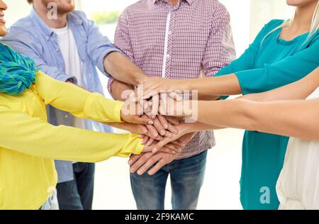 group of students stacking hands Stock Photo