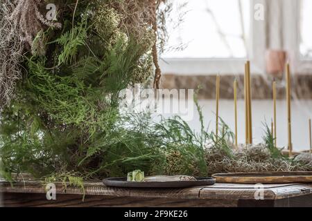 Table setting with Handmade craft plates on rustic old wood table and wood accessories in earth tones boho style Stock Photo