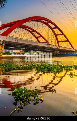 Beautiful sunset on Binh Loi Bridge new and old by night in the rush hour, Ho Chi Minh City, Vietnam. Travel and landscape concept. Stock Photo