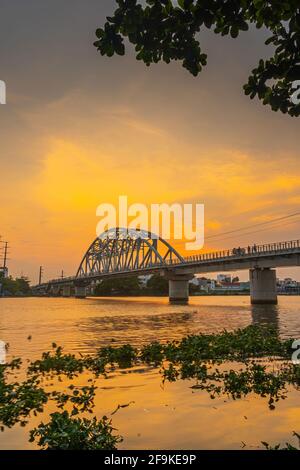 Beautiful sunset on Binh Loi Bridge new and old by night in the rush hour, Ho Chi Minh City, Vietnam. Travel and landscape concept. Stock Photo