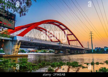 Beautiful sunset on Binh Loi Bridge new and old by night in the rush hour, Ho Chi Minh City, Vietnam. Travel and landscape concept. Stock Photo