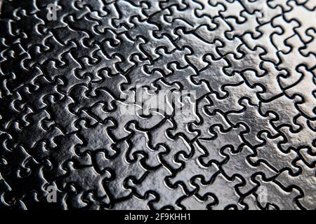 Black jigsaw puzzle pieces background Stock Photo