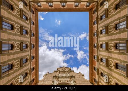 View from the courtyard of Basilica in the Benedictine Abbey of Montserrat (Santa Maria de Montserrat) in Catalonia, Spain Stock Photo