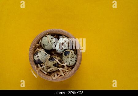 Happy Easter. Quail eggs in the wooden basket, selective focus Stock Photo