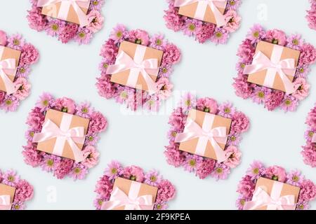 Pattern made of gift boxes. Floral festive concept on a blue background. Stock Photo