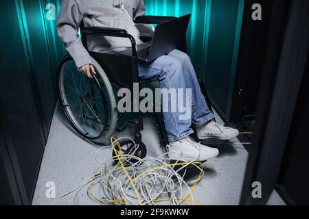 Cropped portrait of disabled woman working in server room and managing internet network, accessible job concept, copy space Stock Photo