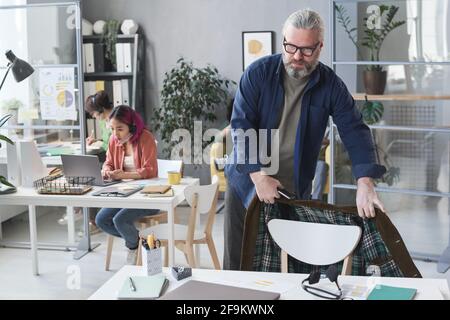 Mature businessman finishing his work at office and going home Stock Photo
