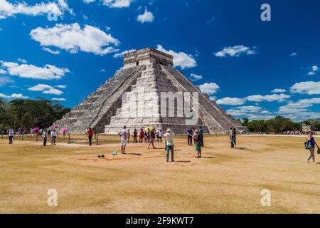 CHICHEN ITZA, MEXICO - FEB 26, 2016: Crowds of tourists visit the Kukulkan pyramid at the archeological site Chichen Itza. Stock Photo